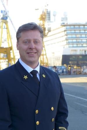 Capt. Emiel de Vries at the shipyard with the ms Koningsdam in the background. Shortly before the final departure.
