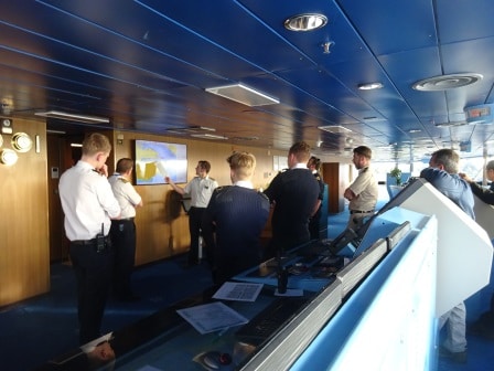 Staff Captain Andrew Barker briefing the team for departure. The Captain is the 2nd one on the left, the local pilot is on the far right.